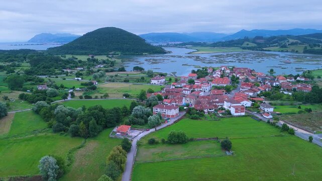 Church of Santa Cruz and town of Escalante seen from a drone in the Parque Natural de las Marismas de Santo&ntilde;a, Victoria y Joyel Natural Park. Cantabrian Sea. Escalante, Cantabria, Spain, Europe