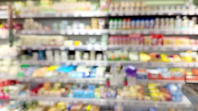 Hand Holding Cottage Cheese in Supermarket &ndash; Dairy Products in Front of Blurred Shelves