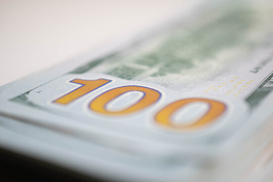 Stack of hundred dollar bills selective focus copy space image focus on Nb 100