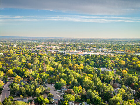 Fort Collins downtown in northern Colorado in morning light, late summer or early fall sunrise aerial scenery