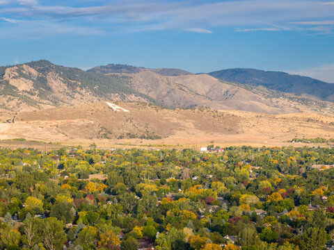 foothills of Rocky Mountains over city of Fort Collins, Colorado, with large iconic letter A painted on rocks