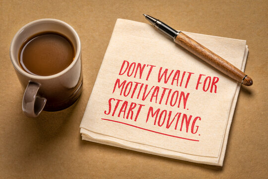 Don't wait for motivation. Start moving. Motivational quote on a napkin with coffee. Concept of taking action, overcoming procrastination, building habits, and making progress.