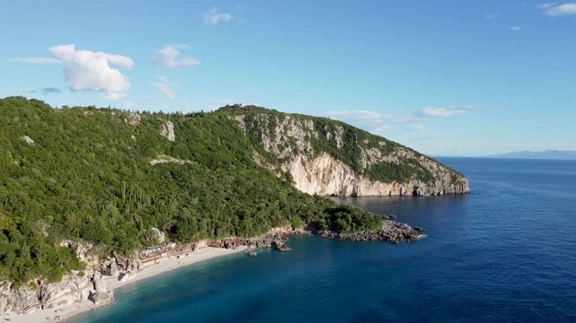 Vlor&euml; rugged coastline featuring sheer white cliffs along the Albanian Riviera. Breathtaking aerial drone view of the dramatic Llogara mountain and sea interface. Steep rocky white cliffs