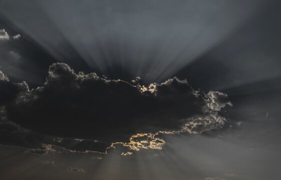 Sun shining behind a cloud, Etosha National Park, Namibia