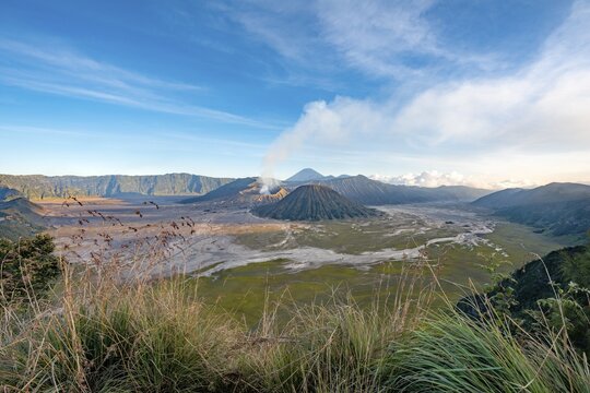 View of volcanic landscape, volcanoes, smoking volcano Gunung Bromo, Mt. Batok, Mt. Kursi, Mt. Gunung Semeru, Bromo-Tengger-Semeru National Park, Java, Indonesia