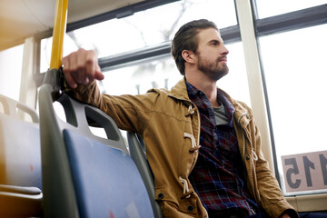 Naklejka na ściany i meble Travel, thinking and man on bus for journey, morning commute and trip on vacation. Public transport, passenger and person with thoughts, vision or daydreaming on holiday for tourism with reflection