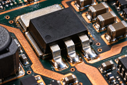 Ultra realistic macro photograph of a modern power MOSFET on high performance PCB with exposed thermal pad, copper traces and solder joints, industrial electronics technology detail