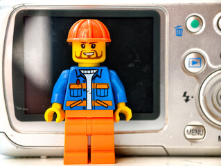 Naklejka premium Russia, St. Petersburg, August 8, 2020 A lego man standing in front of a camera, ready to capture the moment