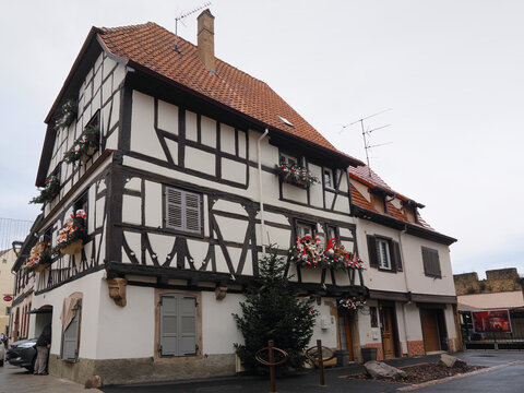 Historic German-French half-timbered building with distinctive black and white facade and red tile roof, Obernai, Alsace, France