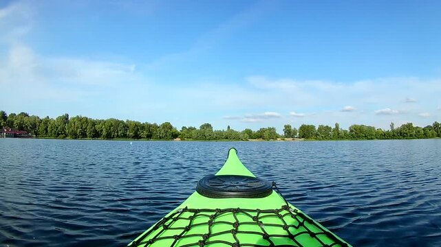Green kayak floating on river
