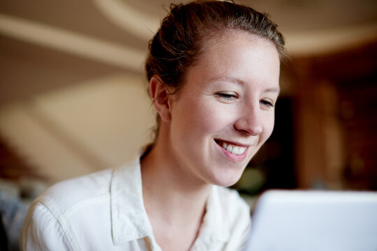 Happy, reading and woman on laptop in home for online project, freelance career and copywriting. Remote work, house and person on computer for article review, editing report and digital publishing