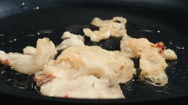 Fat tailed sheep lamb Lard with a golden crust is melted in a stainless steel pan. Cooking traditional uzbek dish, middle eastern food. 