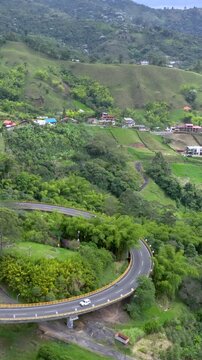 La Estampilla Curved Viaduct near Manizales, Colombia. Establishing Shot. Aerial View. Vertical Video.