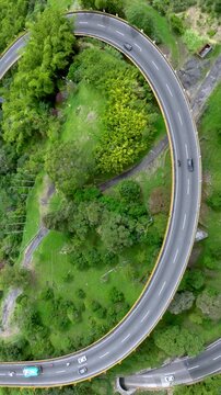 La Estampilla Curved Viaduct Crossing Mountain Terrain near Manizales, Colombia. Aerial View. Vertical Video.