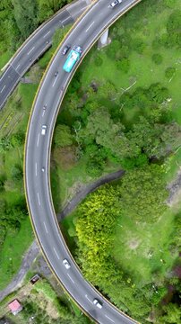 La Estampilla Curved Viaduct Crossing Mountain Terrain near Manizales, Colombia. Aerial View. Vertical Video.