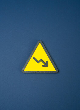 Falling symbol with a downward arrow. A downturn signals losses, falling performance and economic uncertainty. Declining trend warning and bad financial news.