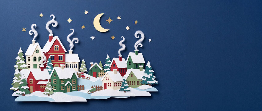 Village de No&euml;l enneig&eacute; en papier d&eacute;coup&eacute;, nuit &eacute;toil&eacute;e sur fond bleu