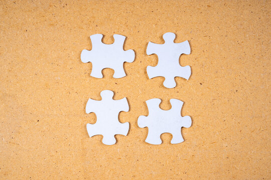 Four puzzles on a brown background