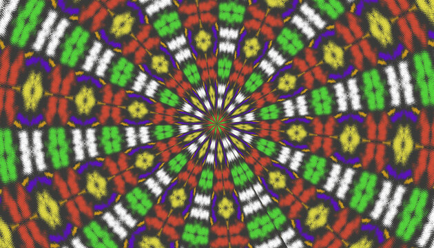 Highly colorful radial kaleidoscopic pattern with repeated floral and geometric motifs arranged around a bright central circular point.
