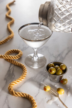 Martini poured with olives on the side
