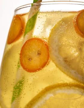 Closeup bubbly drink with citrus slices