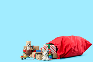 Fototapeta na wymiar Christmas gift delivery and holiday surprise, Santa Claus red sack with wrapped presents and children toys on a blue background for seasonal marketing