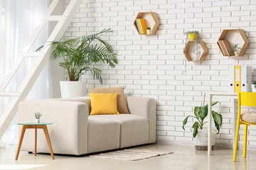 Fotobehang Bosdieren Interior design and home office workspace, modern living room with comfortable sofa and yellow accents in a bright apartment with white brick wall  © Pixel-Shot