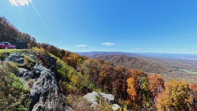 roadside rock outcrop gives way to a broad autumn valley in Shenandoah.

