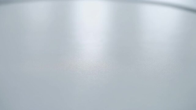 White textured sterile surface rotating under bright laboratory lighting