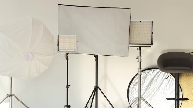Different lighting equipment in photo studio. Camera moving right