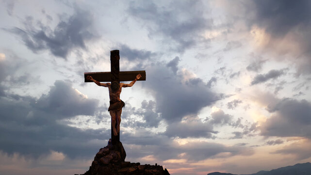 Jesus Christ Crucified on Cross at Golgotha Against Dramatic Cloudy Sky 3D Render