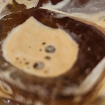 Cute face like pattern on a creamy coffee dessert