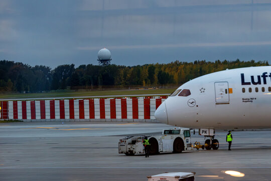 Quebec, Canada, 28 September 2026 : Lufthansa Boeing Dreamliner aircraft maneuvers on airport tarmac assisted by pushback tug and ground crew