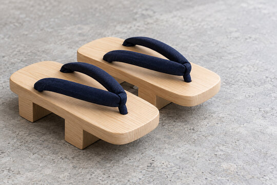 Pair of wooden geta sandals with indigo fabric straps