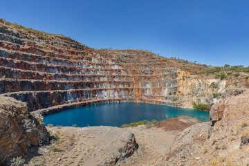 Abandoned open-cut uranium mine with bright blue pool & blue sky background - Mary Kathleen, Cloncurry, Queensland, Australia © Anne Powell