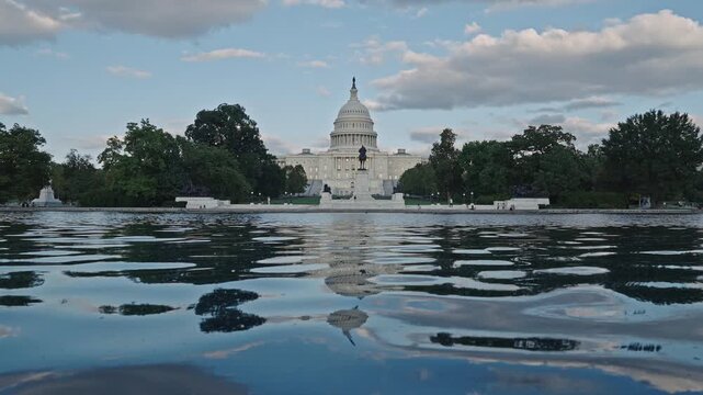 United States Capitol with pool water. Capitol across reflecting pool. Landmark Capitol and reflecting pond. Government landmark in Washington DC USA with water. Capitol reflecting pool. 4k footage