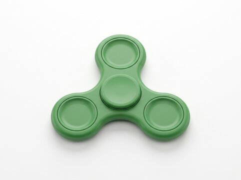 Green fidget spinner toy with three round bearing caps on white background, top view, stress relief hand toy