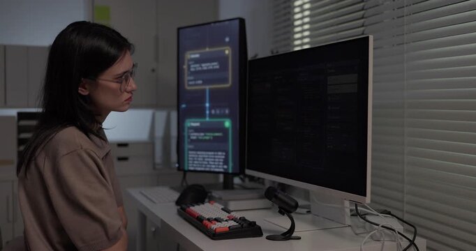  Woman software developer speaking voice prompt to AI assistant chat interface at desk
