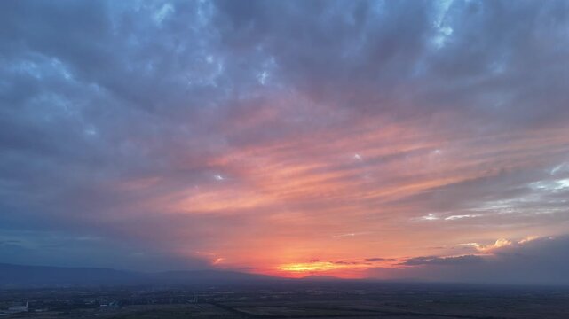 colorful sunset sky with dramatic clouds over landscape