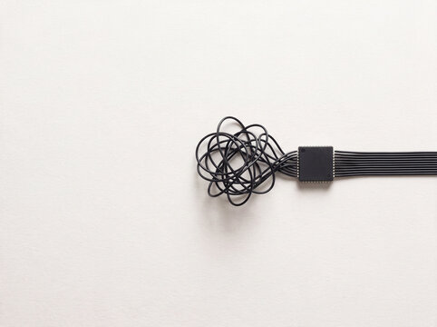 Microchip with tangled wires transforming into neat parallel cables representing data organization and AI processing concept