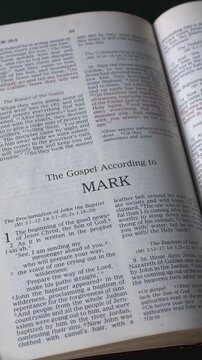 Opening to the book of Mark of the New Testament in the Holy Bible. New Revised Standard Version. Vertical video.