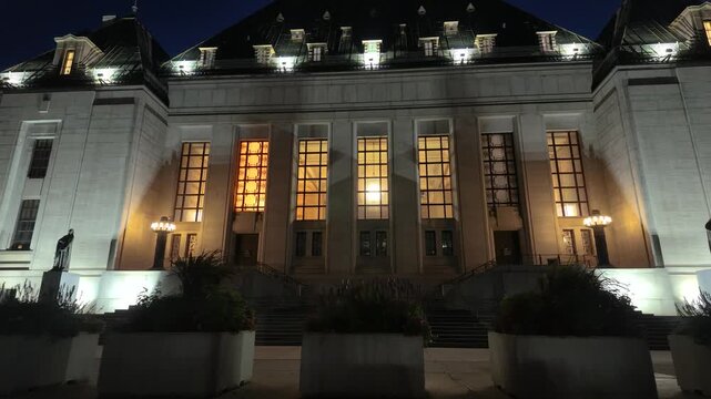 Ottawa, Ontario, Canada - October 7, 2026: Dramatic night view of the illuminated Supreme Court of Canada building facade