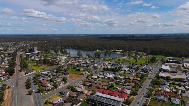 Aerial view of Shepparton suburbs, railway line and lake, Victoria