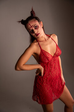 Woman portraying succubus demon in red lingerie