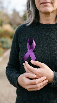 Woman wearing purple awareness ribbon for domestic violence epilepsy Alzheimers lupus pancreatic cancer support