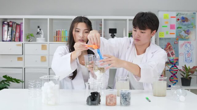 Teenage Students Conducting Water Filtration Science Experiment in Classroom Laboratory