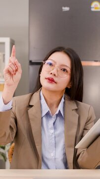 Asian Businesswoman Interacting with Virtual Screen Using Hand Gestures