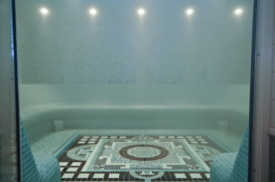 Turkish bath or steam sauna with mosaic tiles inside male locker room of spa or wellness are onboard luxury cruiseship or cruise ship liner