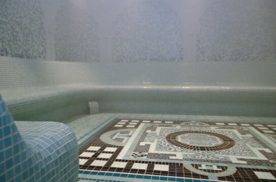 Turkish bath or steam sauna with mosaic tiles inside male locker room of spa or wellness are onboard luxury cruiseship or cruise ship liner