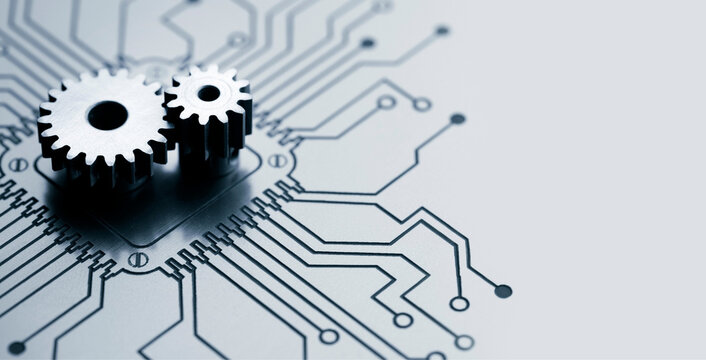 Metal mechanical gears on a printed circuit board processor concept background